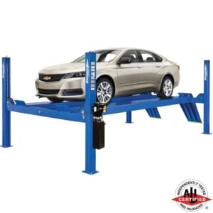Champagne Chevy Impala on a Forward Lift CR14 four-post lift, ideal for alignment and general service, ALI certified