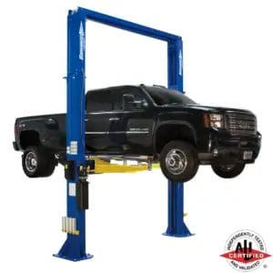 Heavy-duty GMC Denali HD truck raised on a Forward Lift DP15 two-post lift, ALI certified