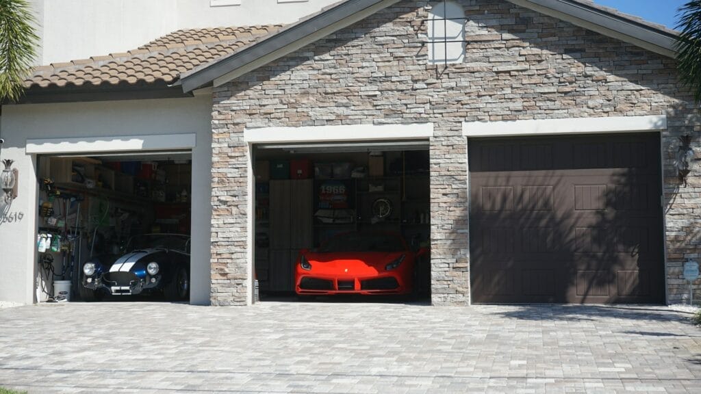 Garage with a red porsche and blue corvette